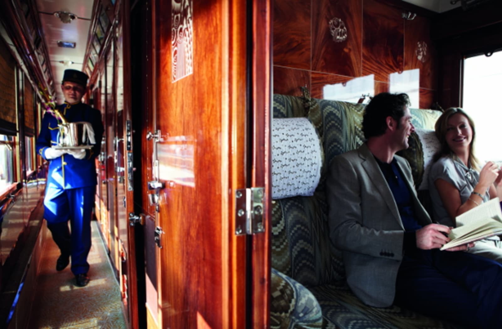 Couple having a fun conversation inside the coach of the Venice Simplon orient express