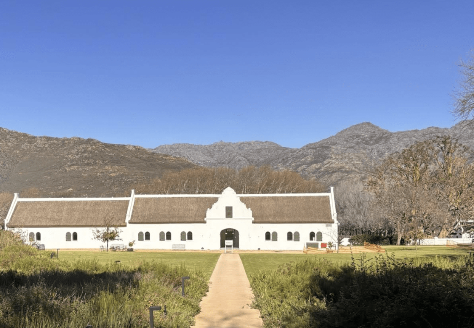 A view of a wine farm's garden and farm house in Cape Town.