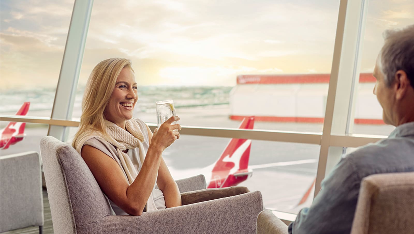 lady sitting in business lounge at airport drinking water