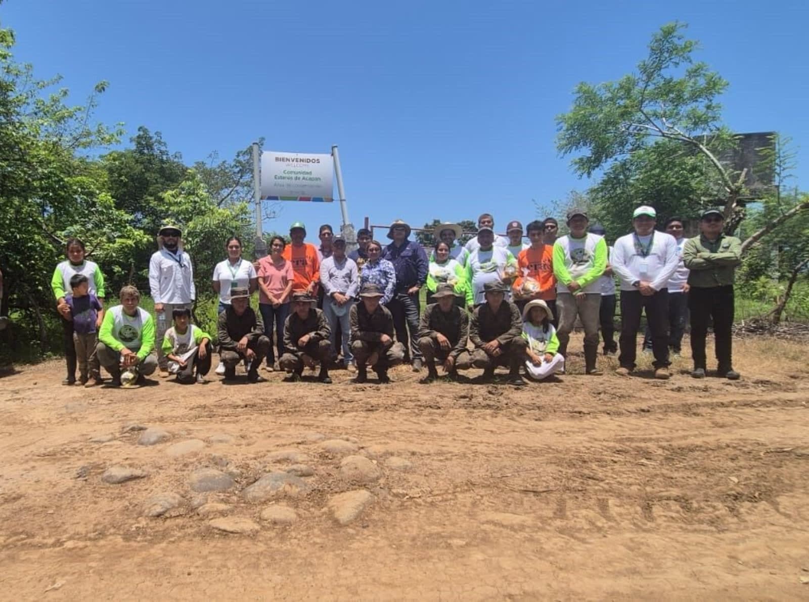 group of people standing on dirt floor 
