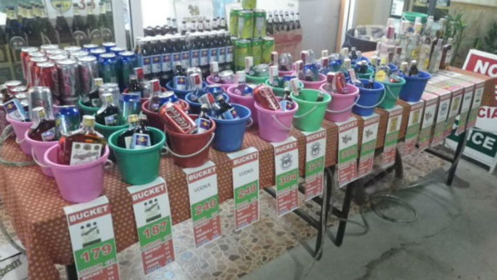 Buckets filled with various cans and bottles of drinks