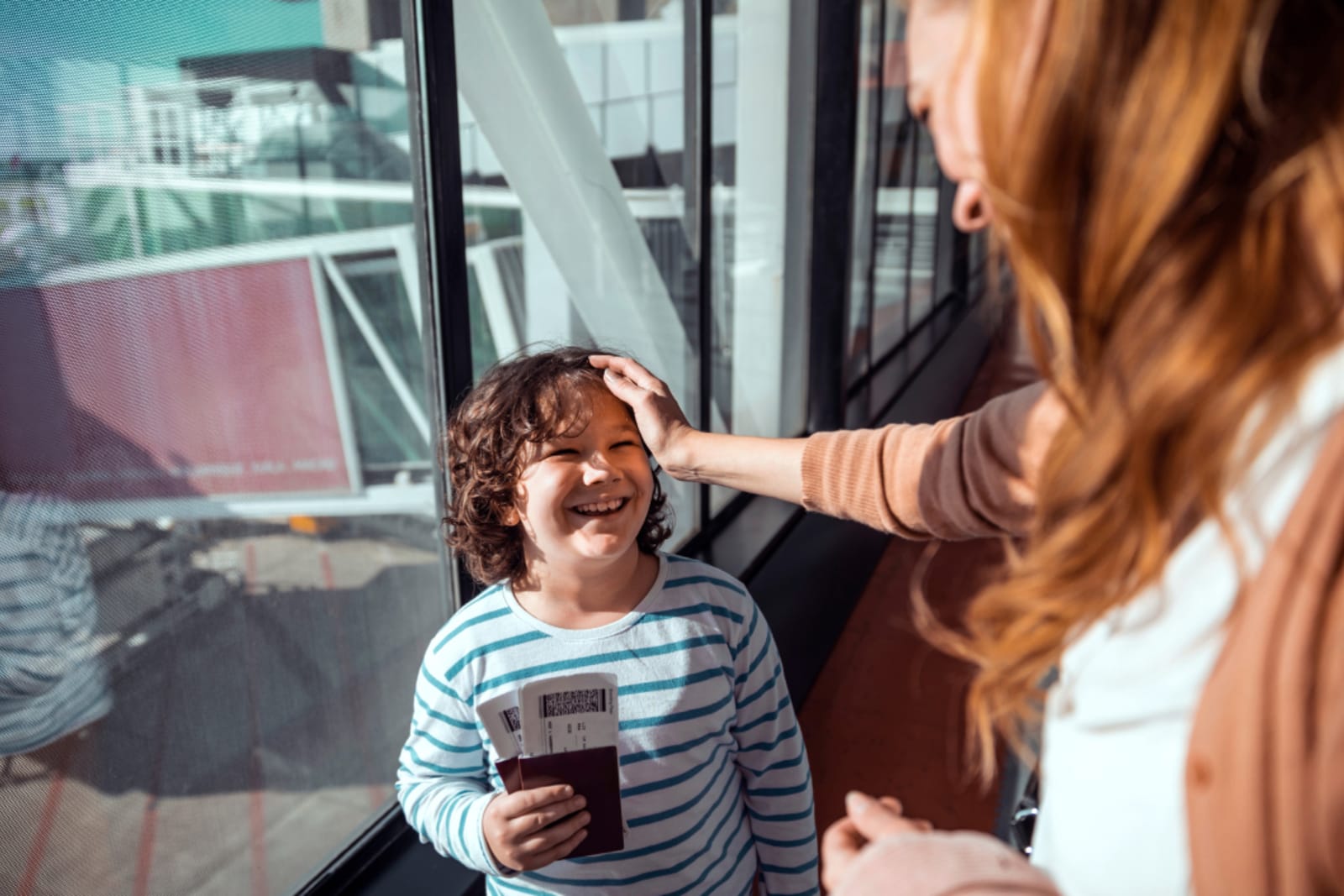 Mother and son waiting to board their plane