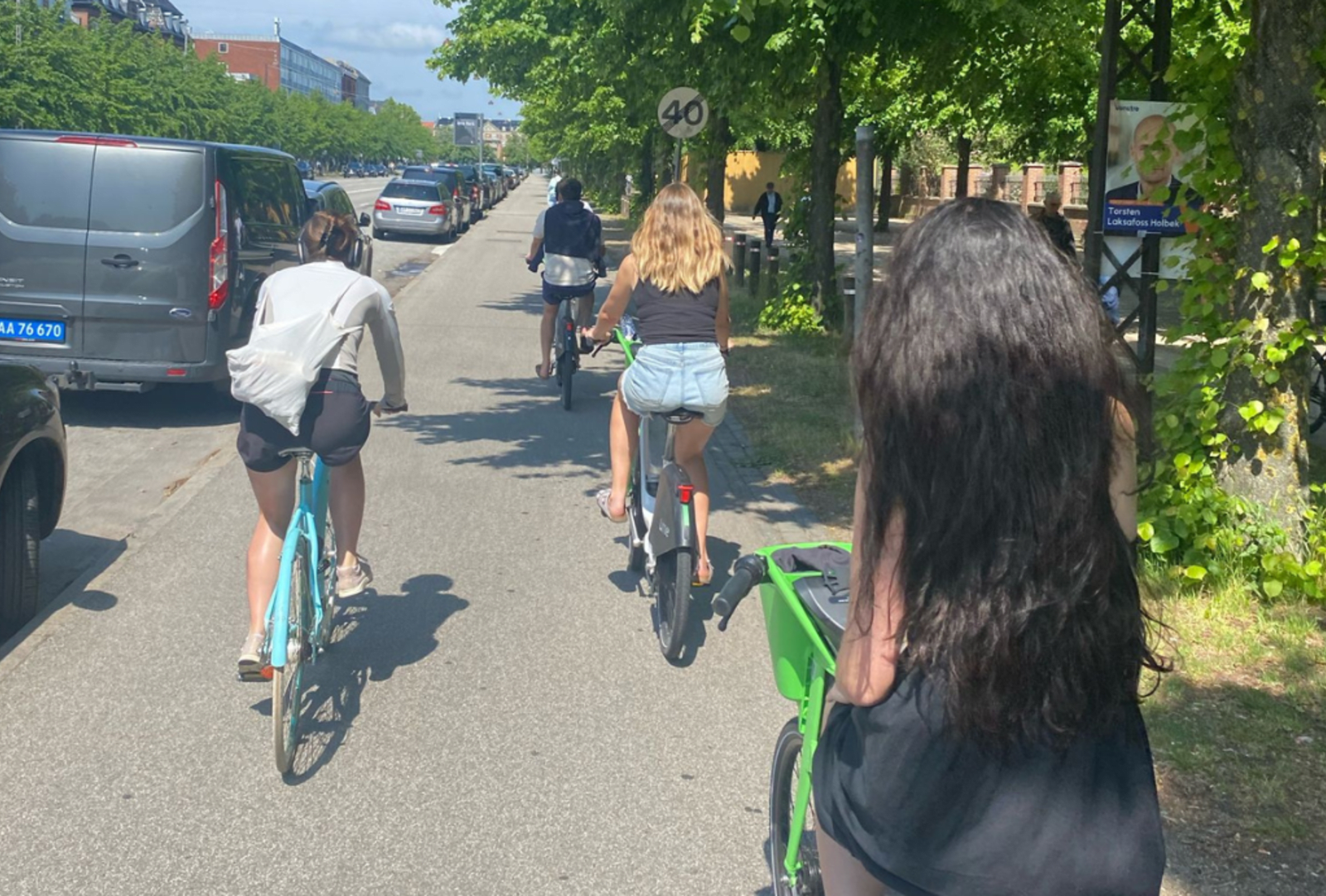Cyclists riding down a footpath in suburban Copenhagen