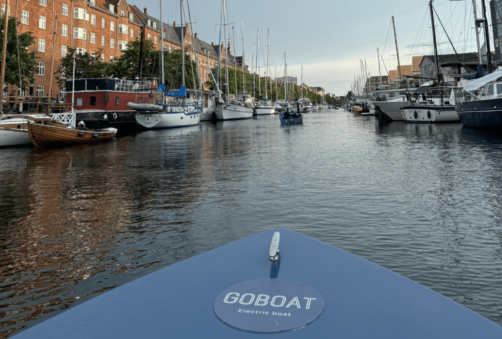 View over the bow of an electric boat in a canal in Copenhagen