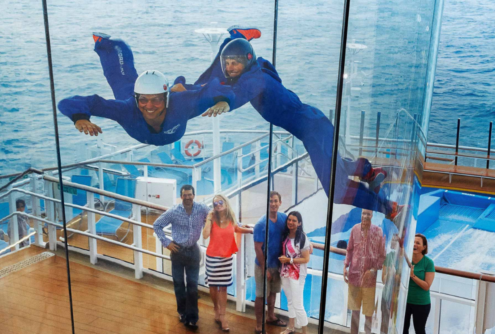 Two people indoor skydive high on deck