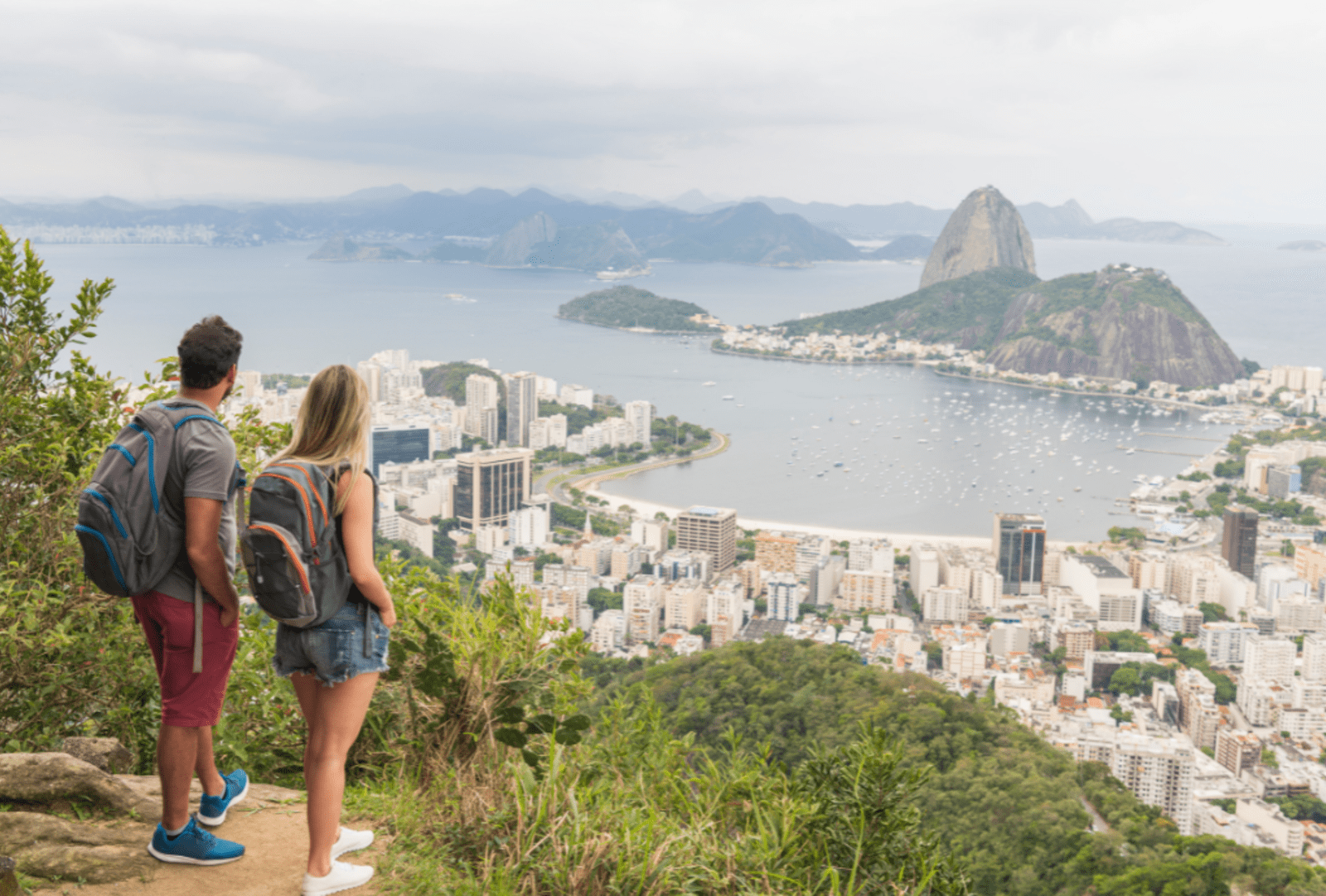 Elevated shot of couple looking at view of the landmark Sugar Loaf Mountain in Rio de Janeiro