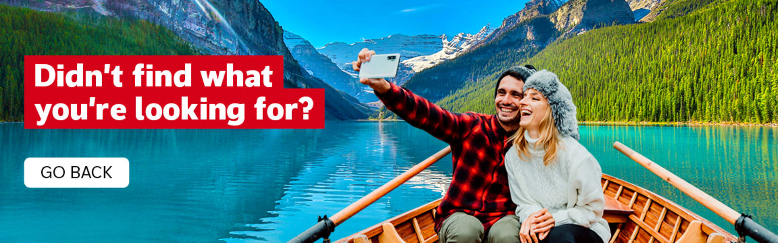 Didn't find what you're looking for? Go back. | couple taking a selfie in a rowboat on Lake Louise in Canada