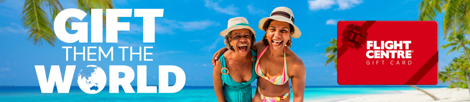 Two women laughing together on a tropical beach with turquoise water and palm trees promoting the Flight Centre Gift Card with Gift Them the World