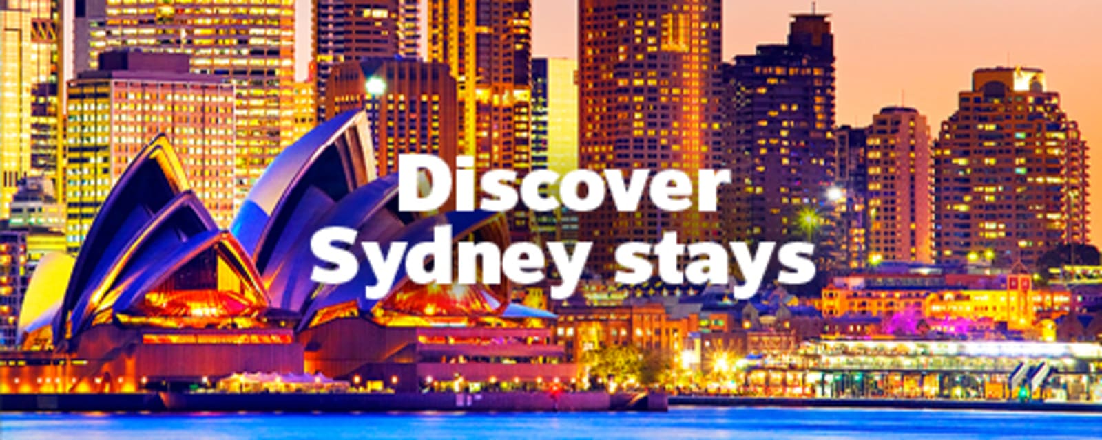 Sydney Opera House and Harbour Bridge illuminated at dusk with city skyline for Discover Sydney stays