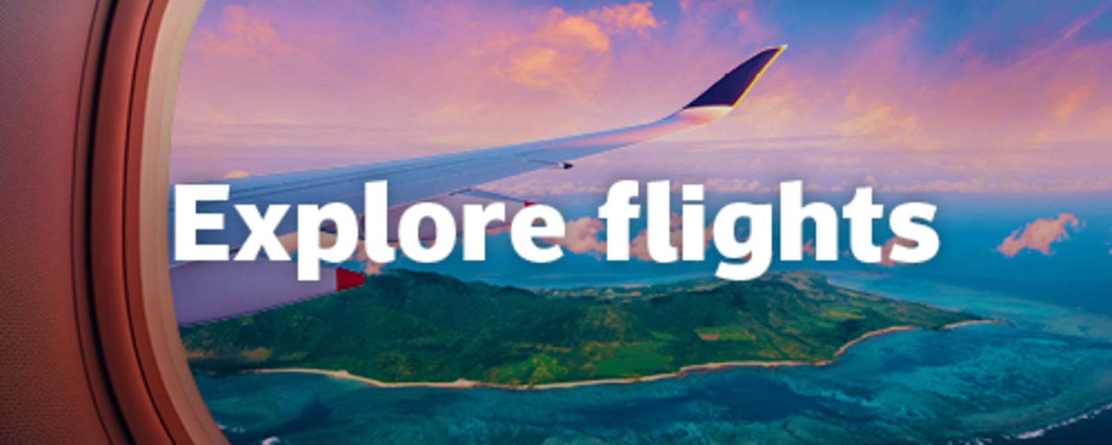 Aeroplane wing view over a lush green island coastline beneath a pastel sunset sky for Explore flights