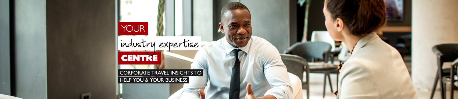 Your industry expertise centre - corporate travel insights to help you & your business. Black businessman and white businesswoman having a meeting over coffee