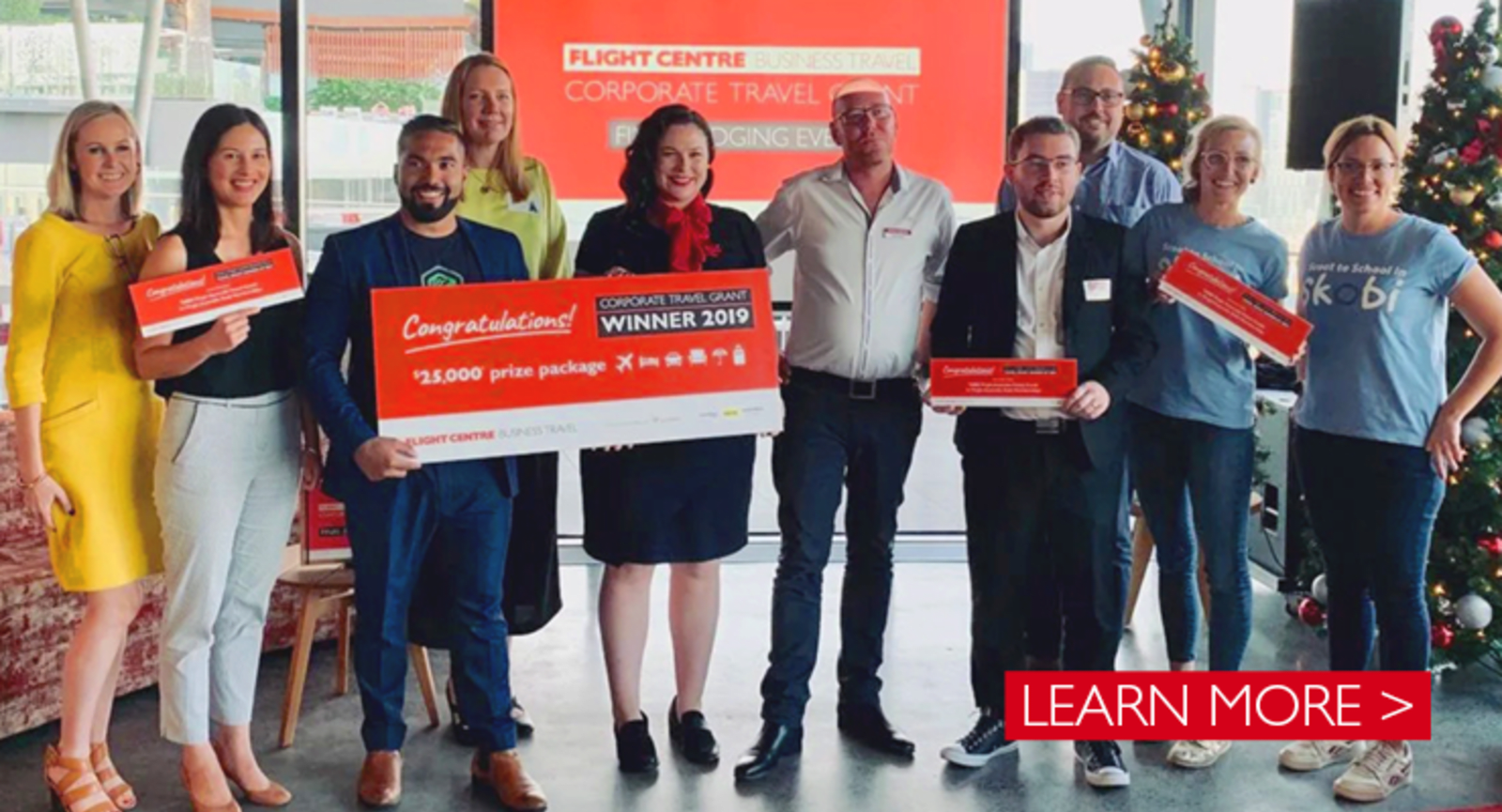 Winners of Flight Centre Corporate Travel grant standing with a cheque