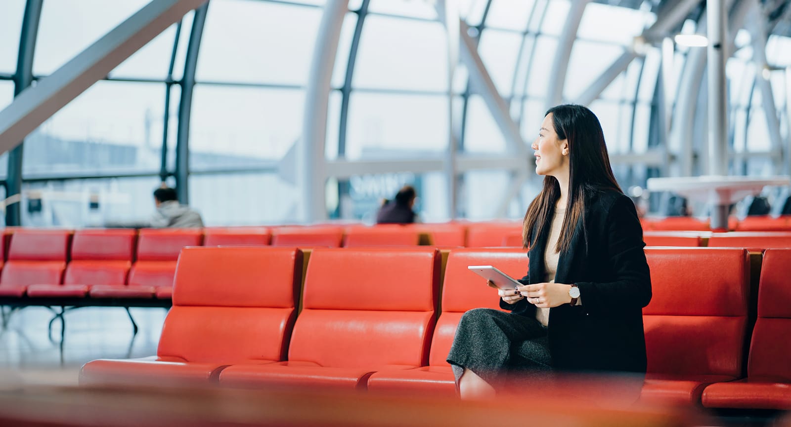 Business woman on tablet in airport