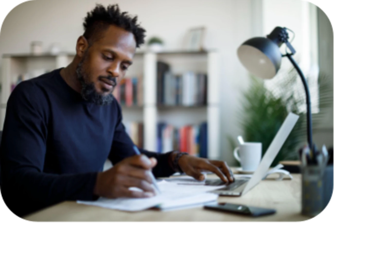 man working in office signing a paper