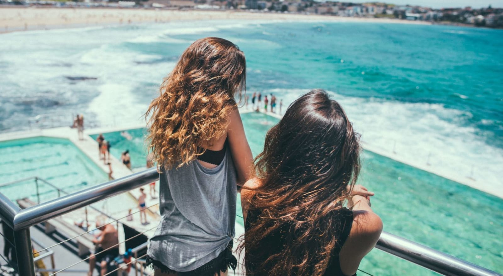 two girls looking over balcony at bondi