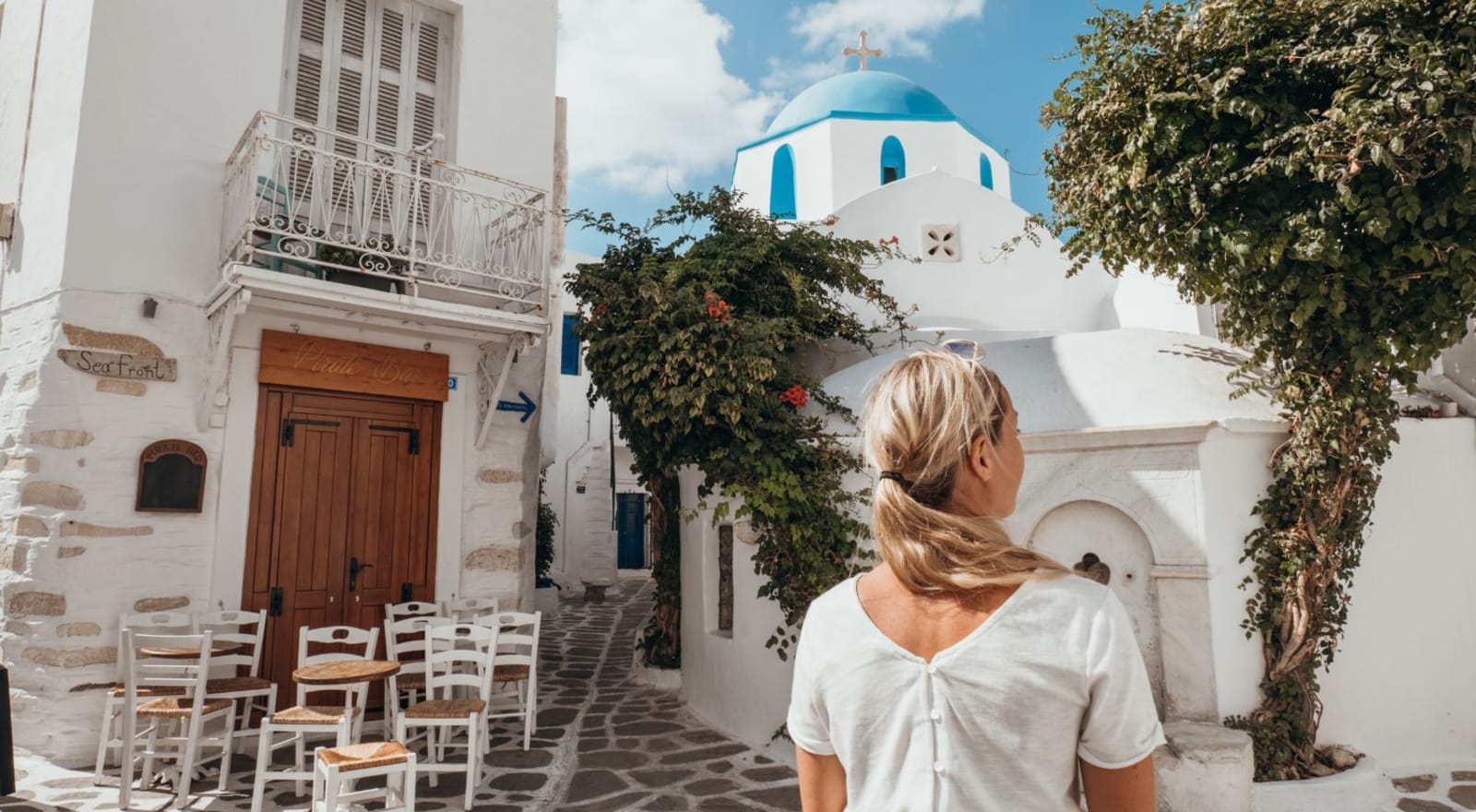 lady walking through street in mykonos