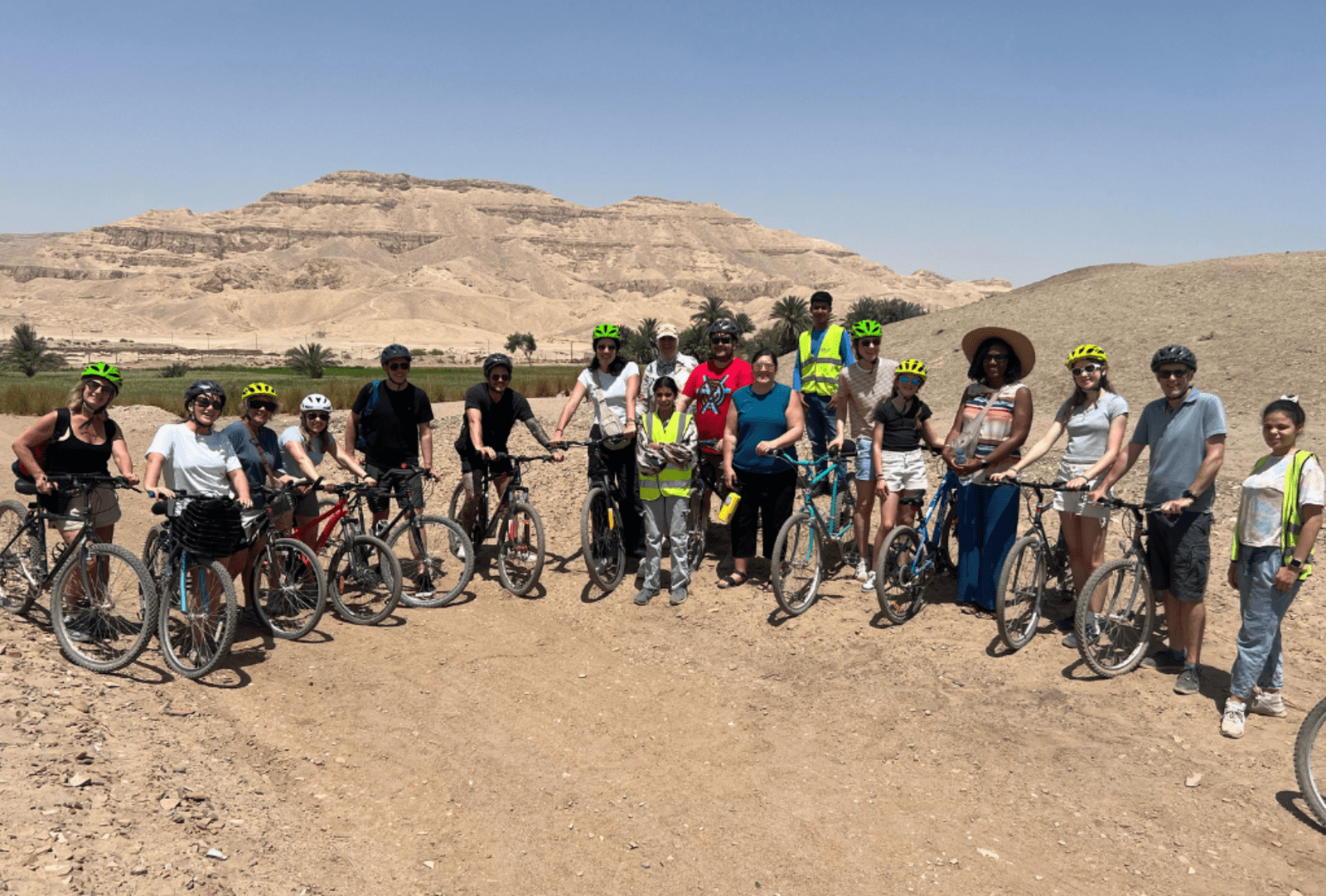 Cyclists stop for a photo with the Valley of the Kings in the Background
