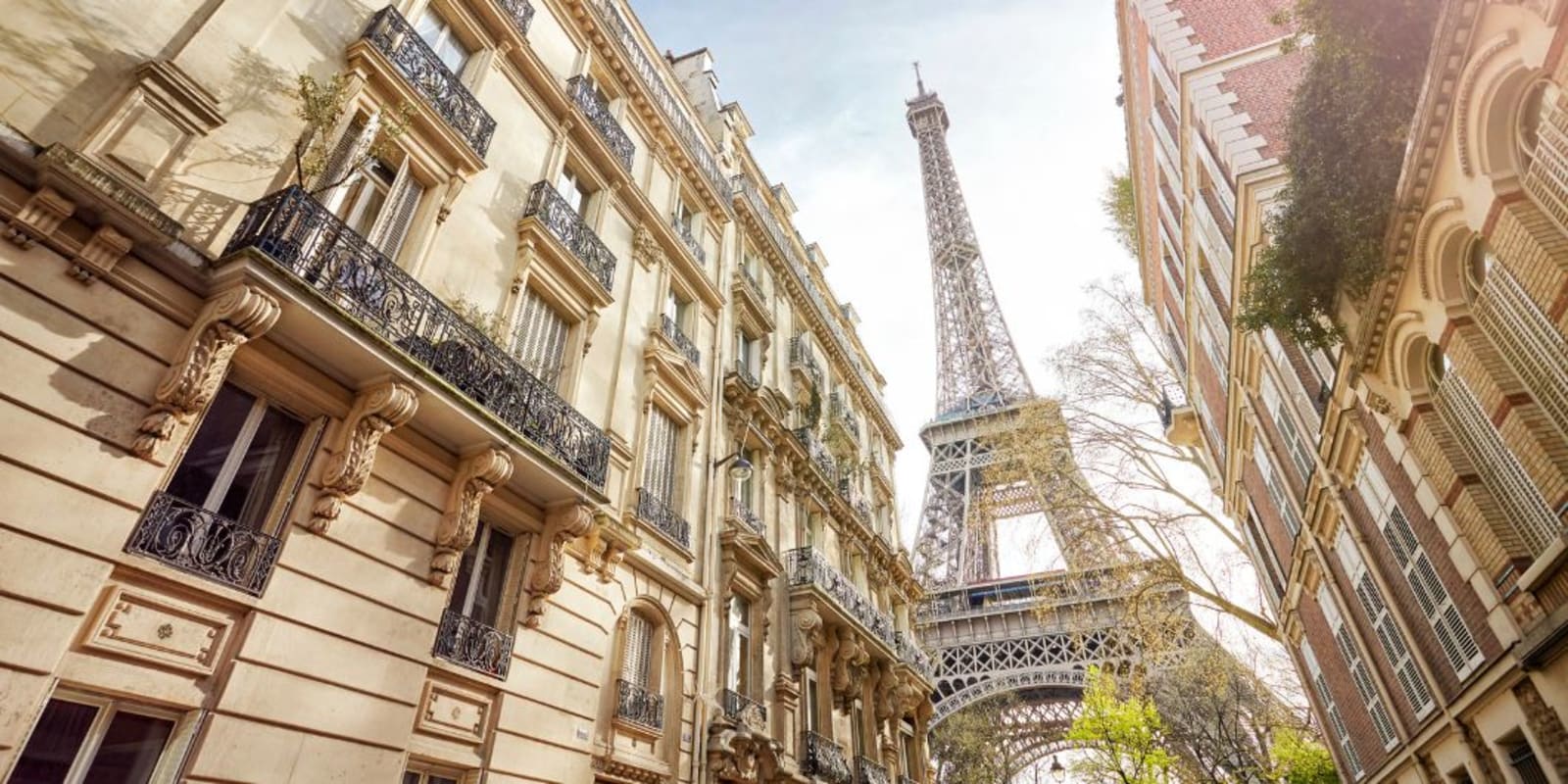 Looking up at the Eiffel Tower from a street in Paris