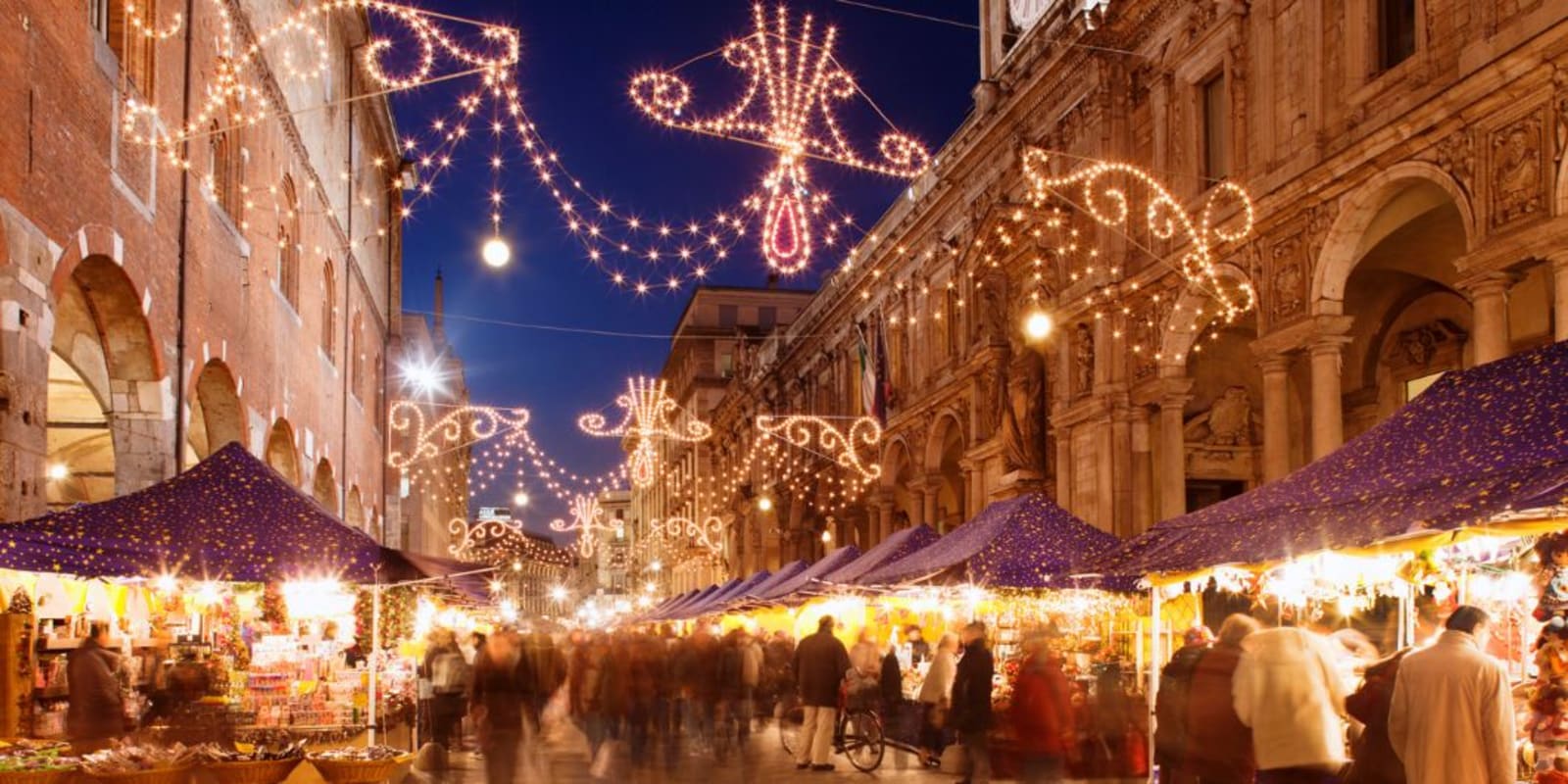 A busy Christmas market in Milan at night