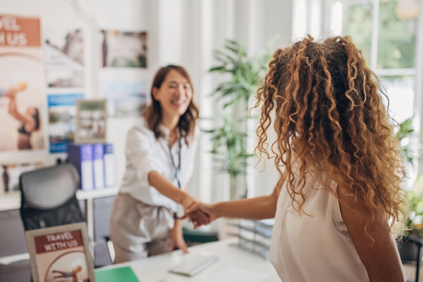 A person shaking hands with a travel consultant
