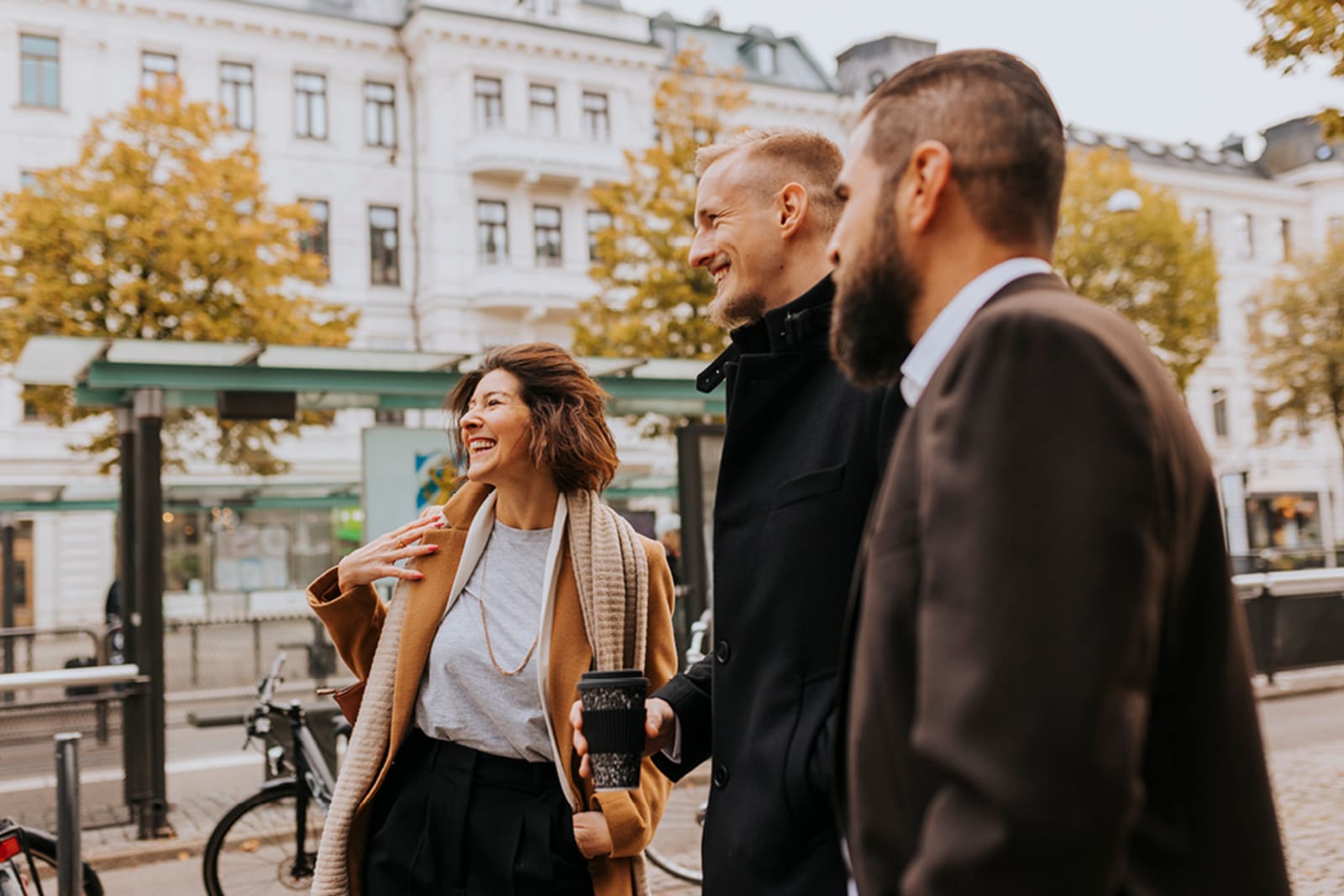 A group of friends waiting at a bus stop in Europe