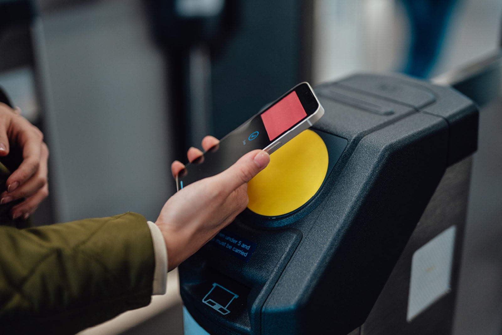 A person scans their public transit ticket using a mobile device