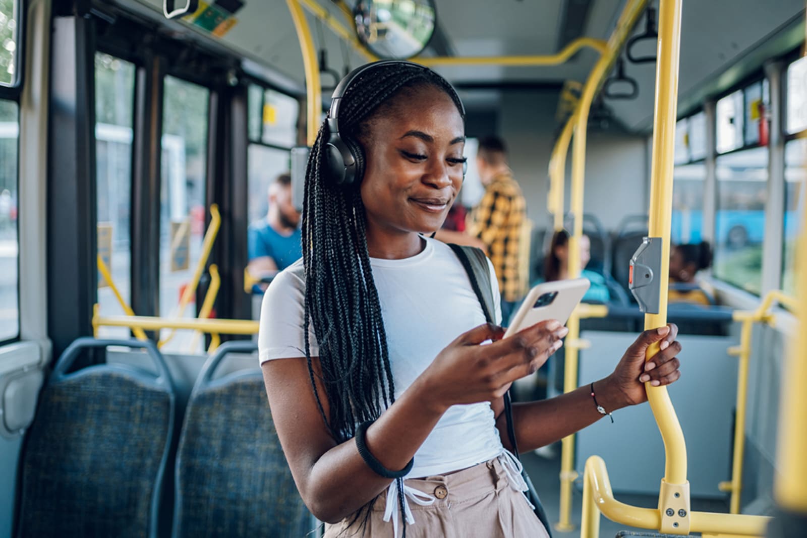 A person wearing headphones on a public bus