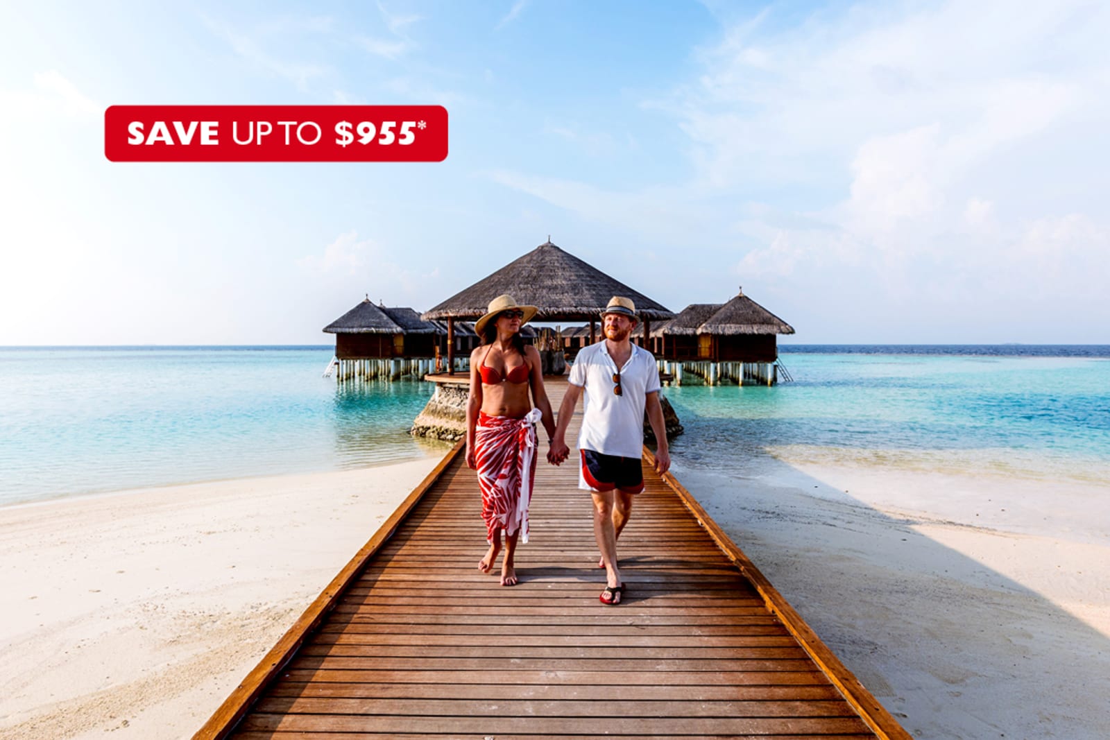 A couple walking on a pier in the Maldives