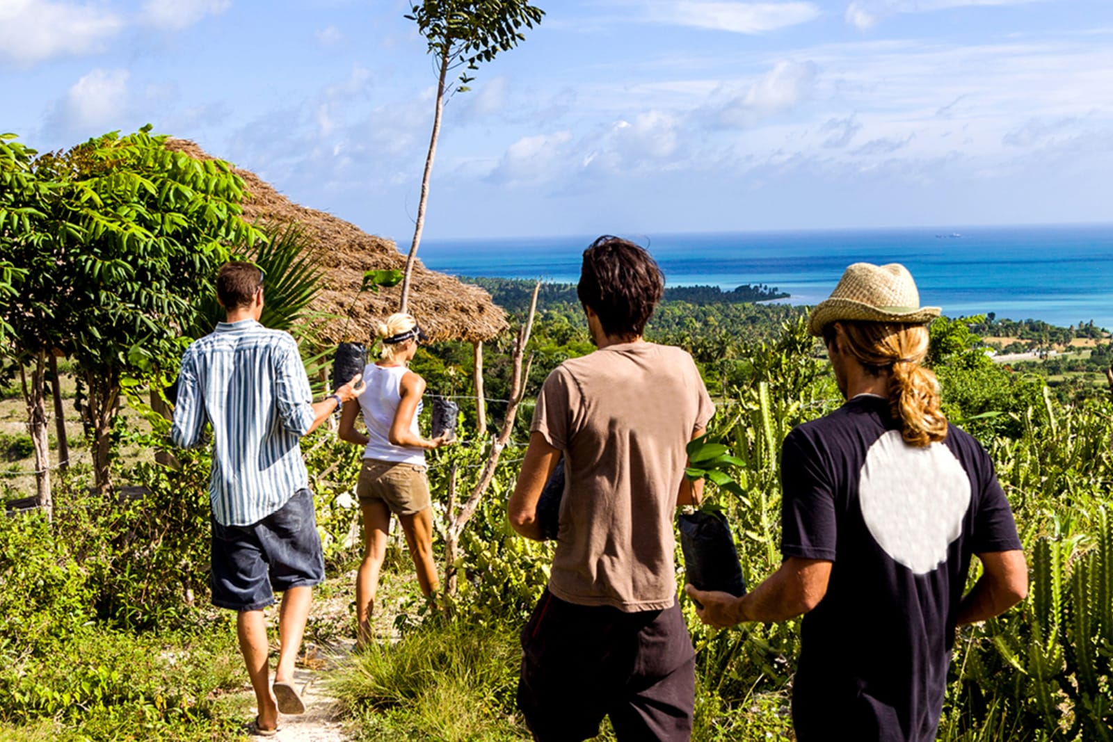 Travellers planting trees during a volunteer trip