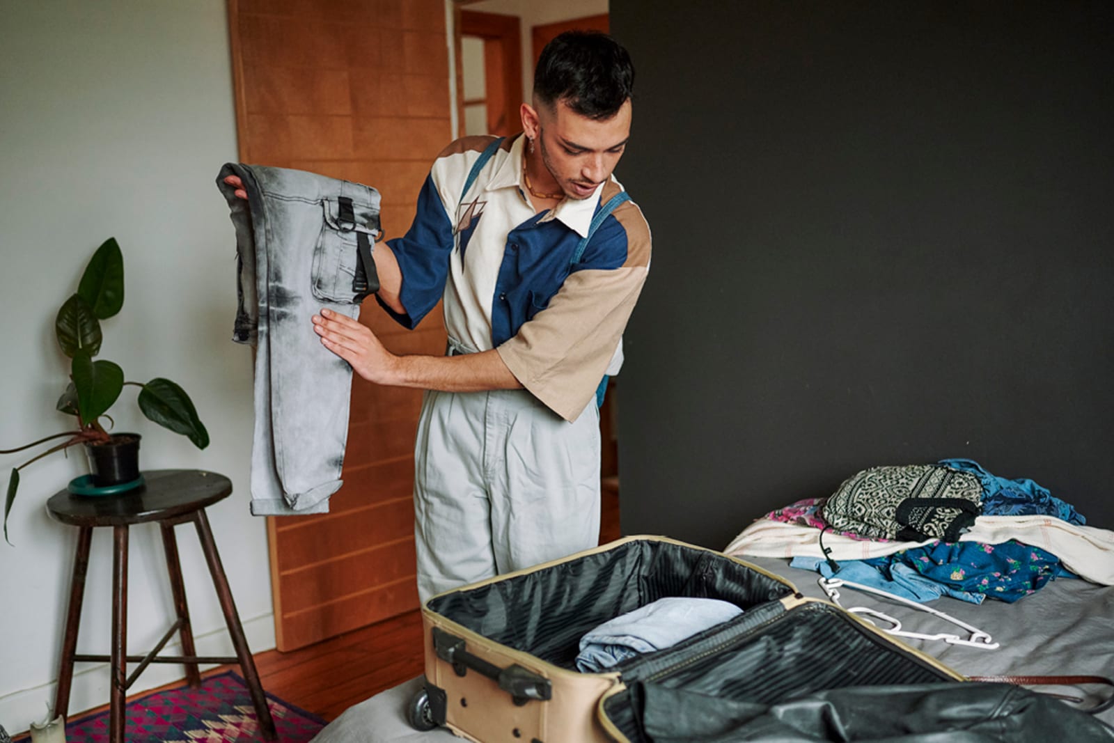 A young man packing his suitcase