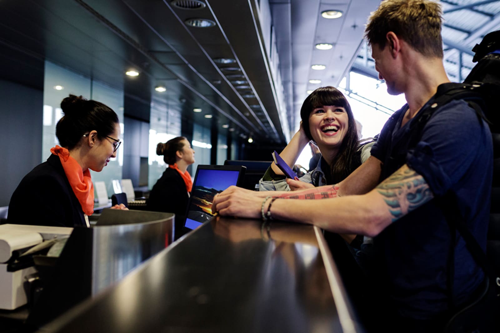People checking in at an airport counter