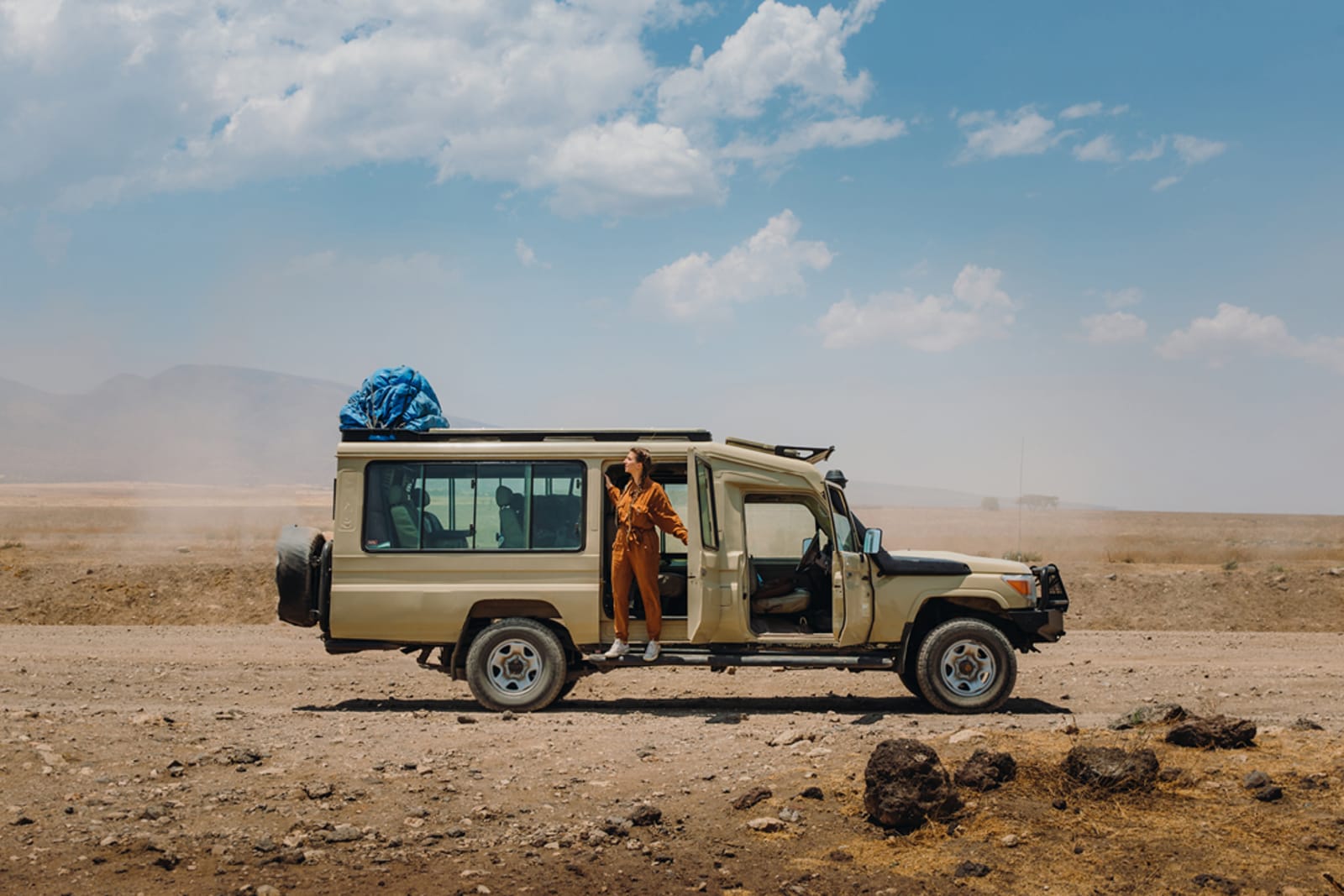 A traveller looking for wildlife on the Northern Circuit in Tanzania