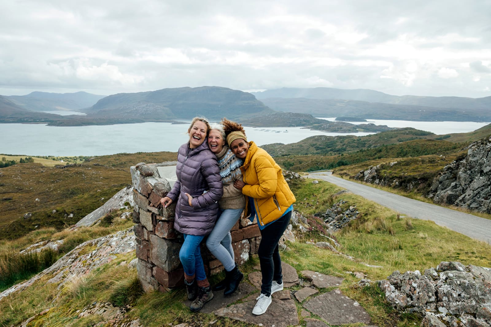 A group of women at the summit of the Applecross Peninsula in Scotland