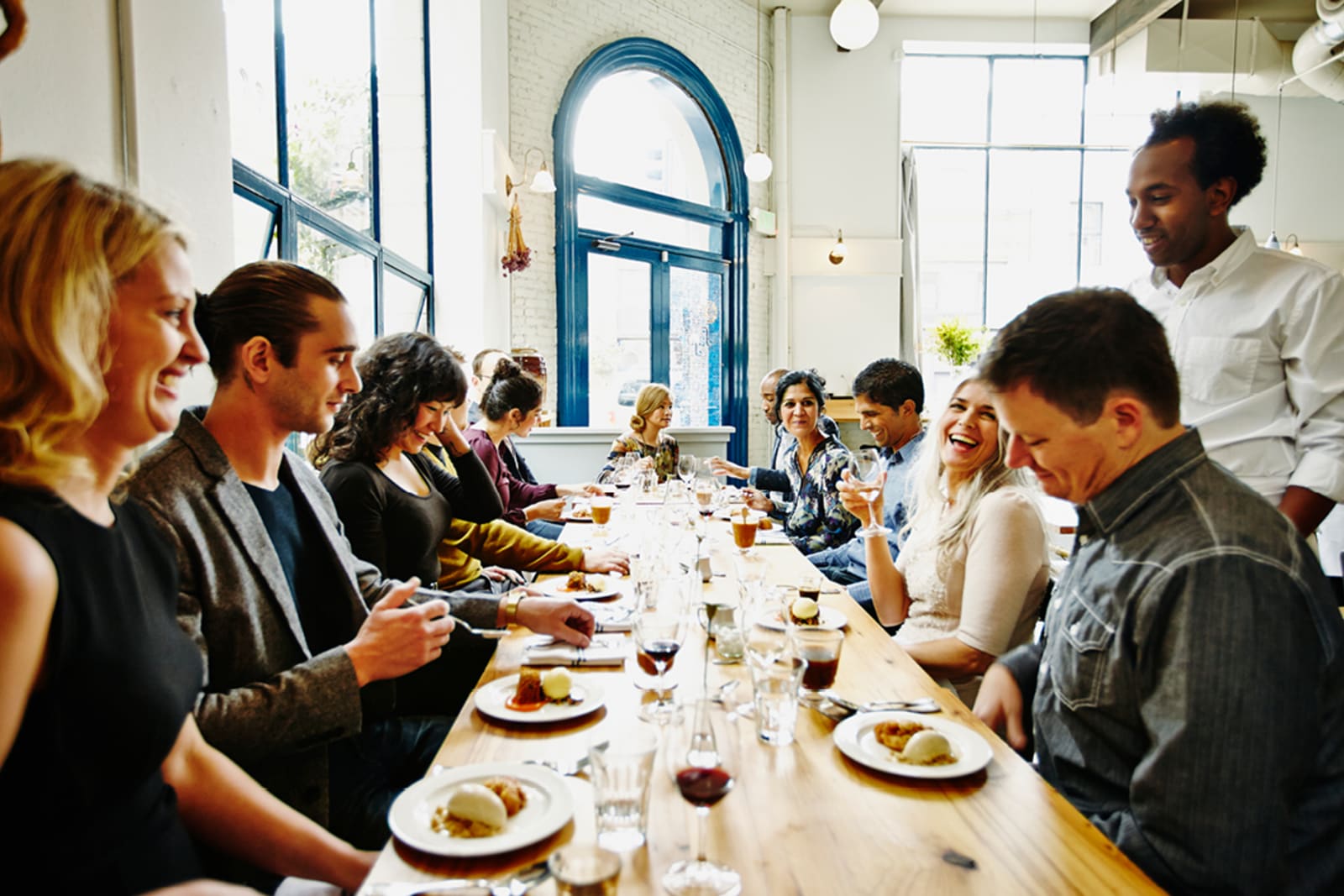 A large group of friends dining at a restaurant