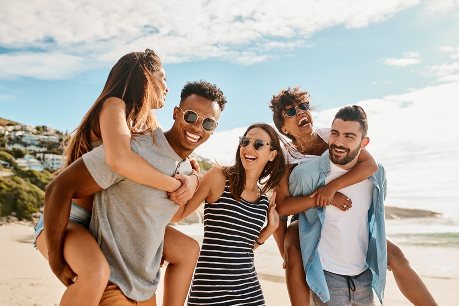 A group of five friends on a beach