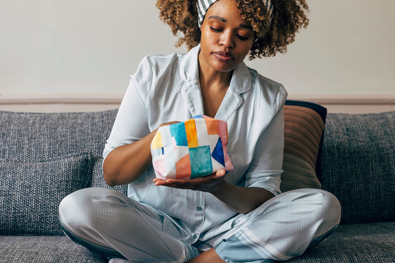 A woman sorting through her toiletry bag in her hotel room