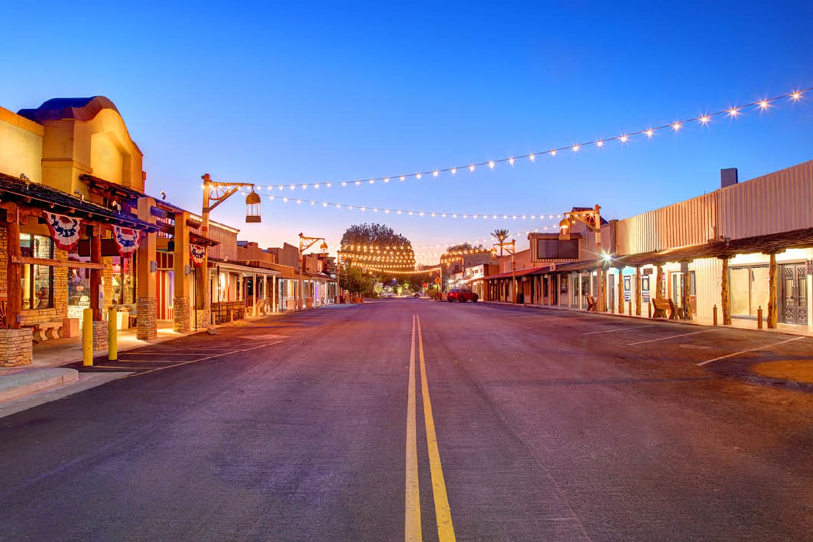 Old Town Scottsdale lit up in the evening with shops and an open road