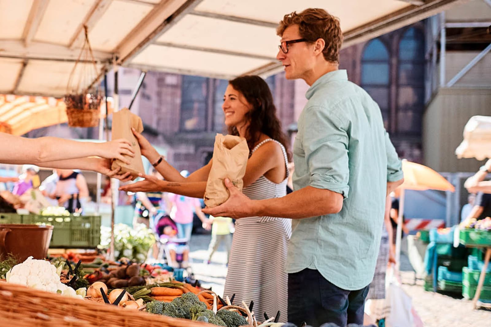 A couple buying produce from a market in Spain