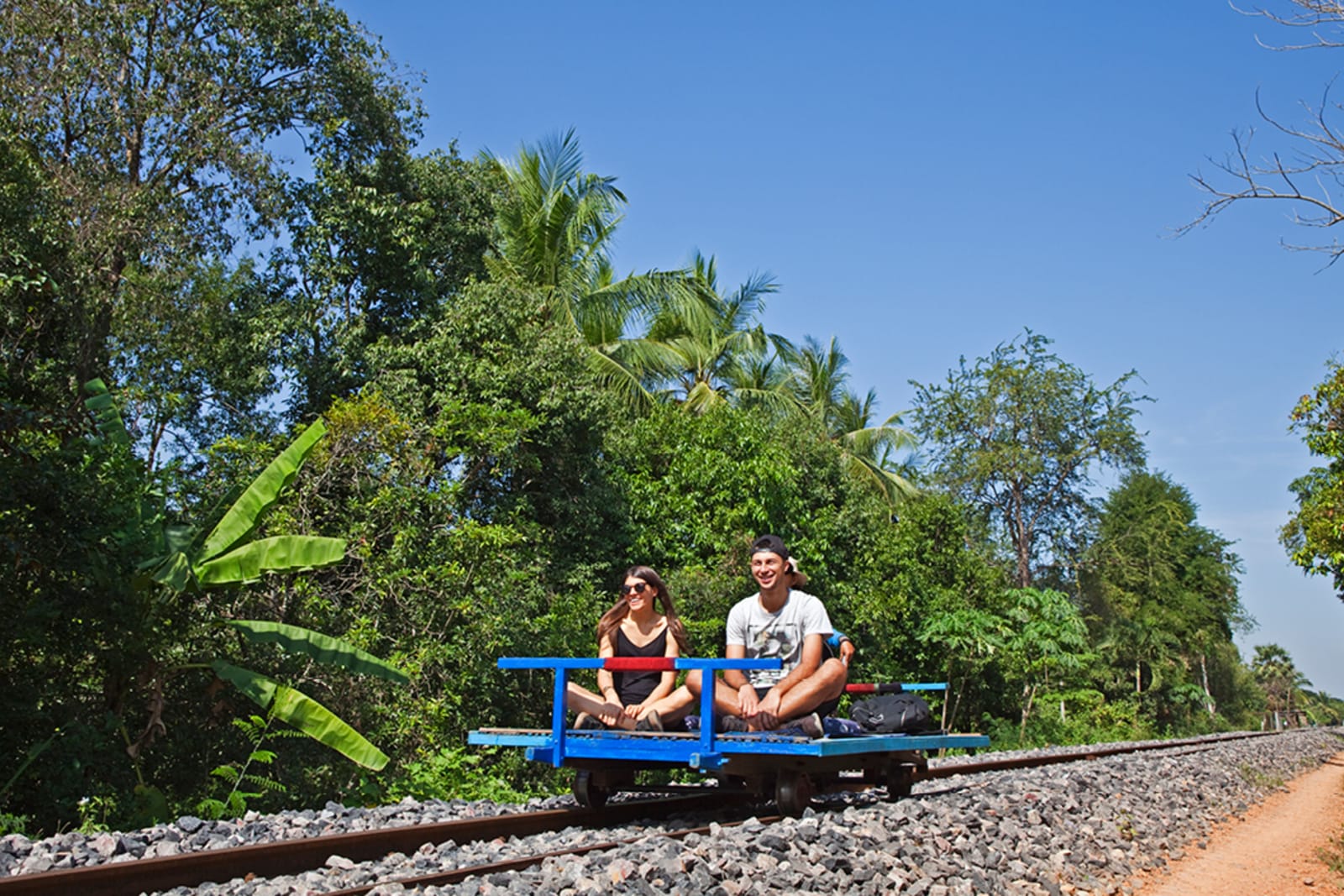 Travellers riding the bamboo train in Battambang, Cambodia