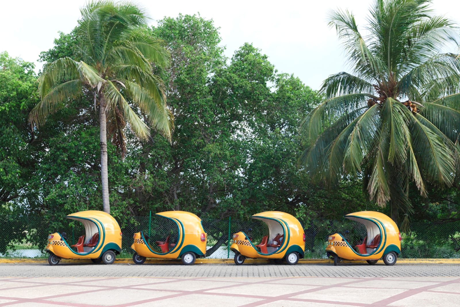 A line of yellow Cocotaxis in Cuba