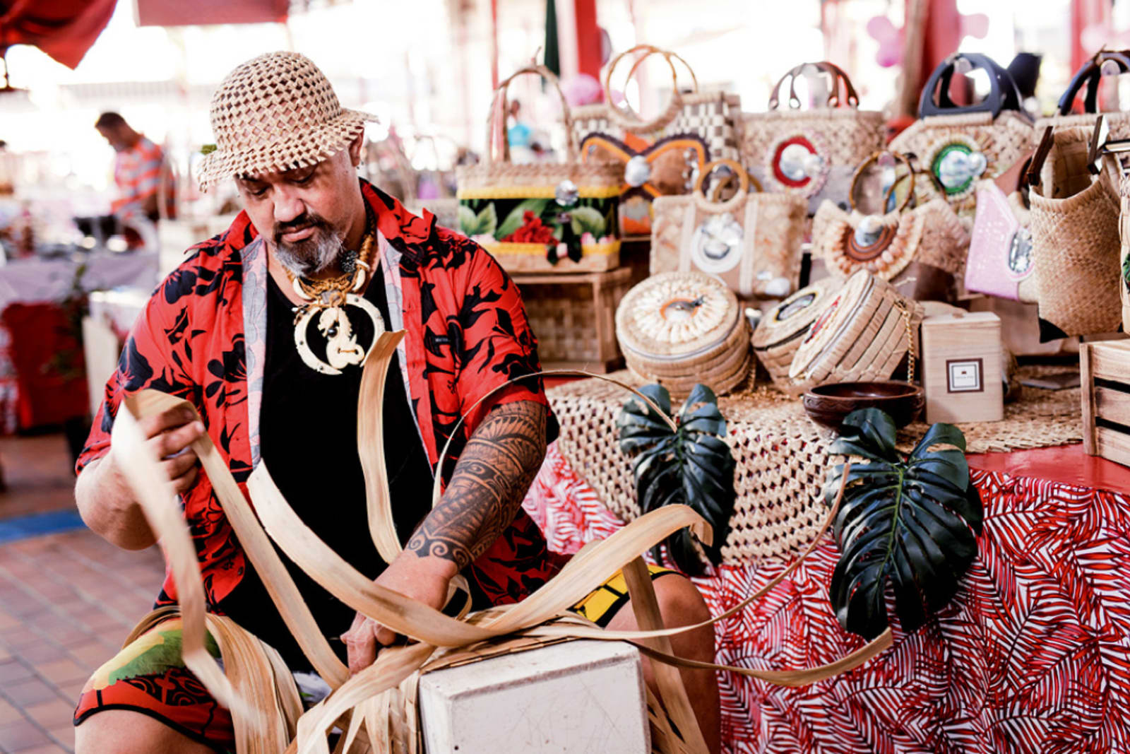 A Tahitian man making wares at the Papeete market