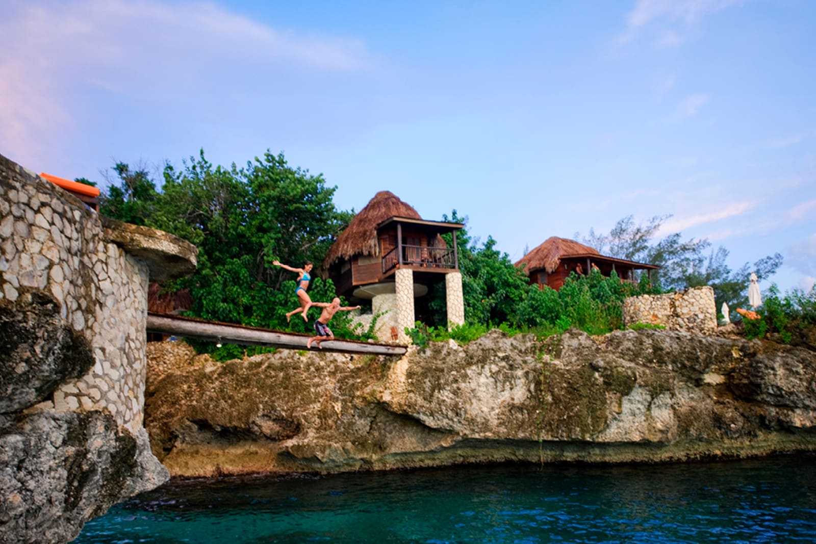 A couple cliff jumping in Jamaica