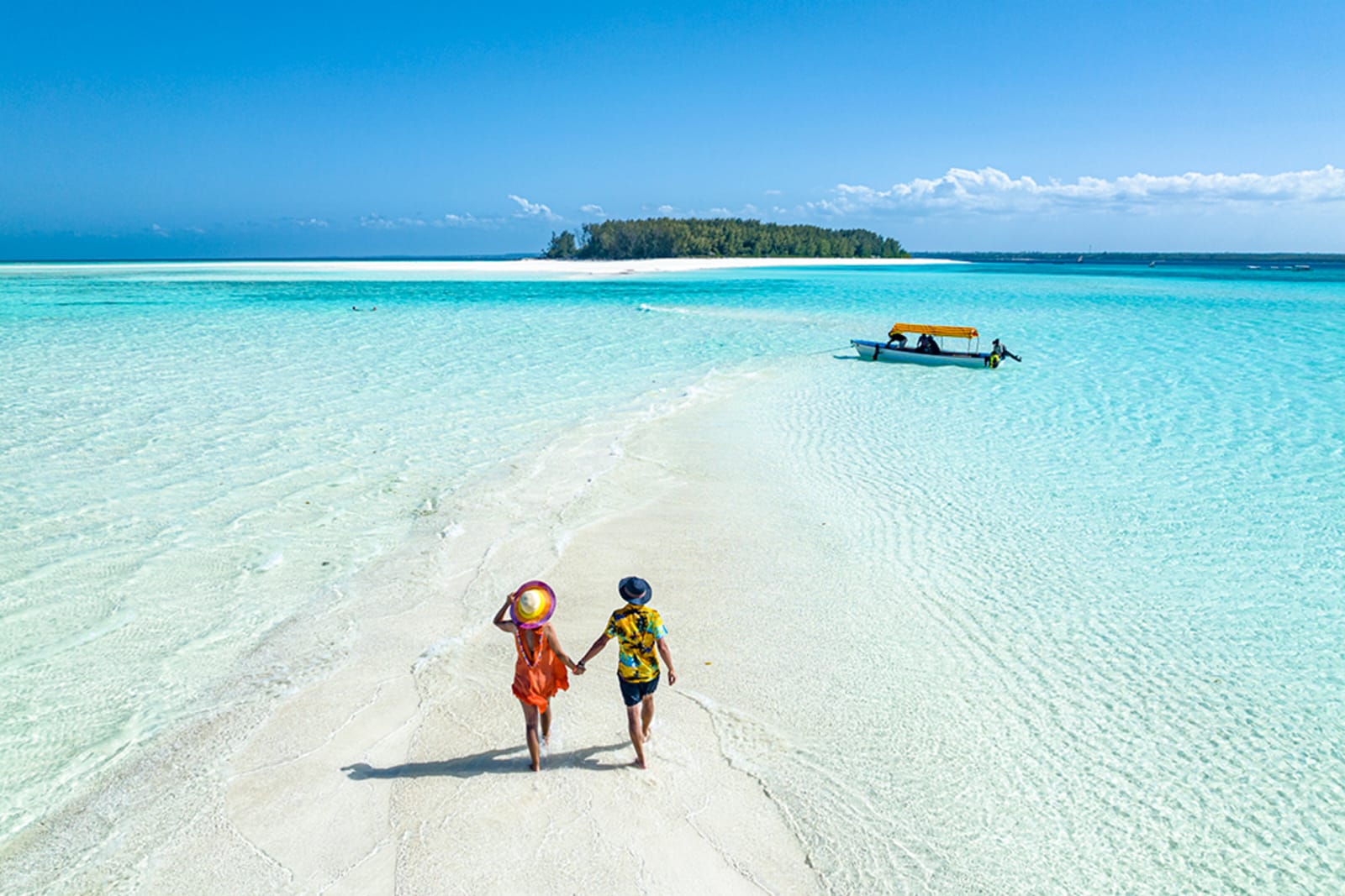 A couple walking on a secluded beach in Zanzibar