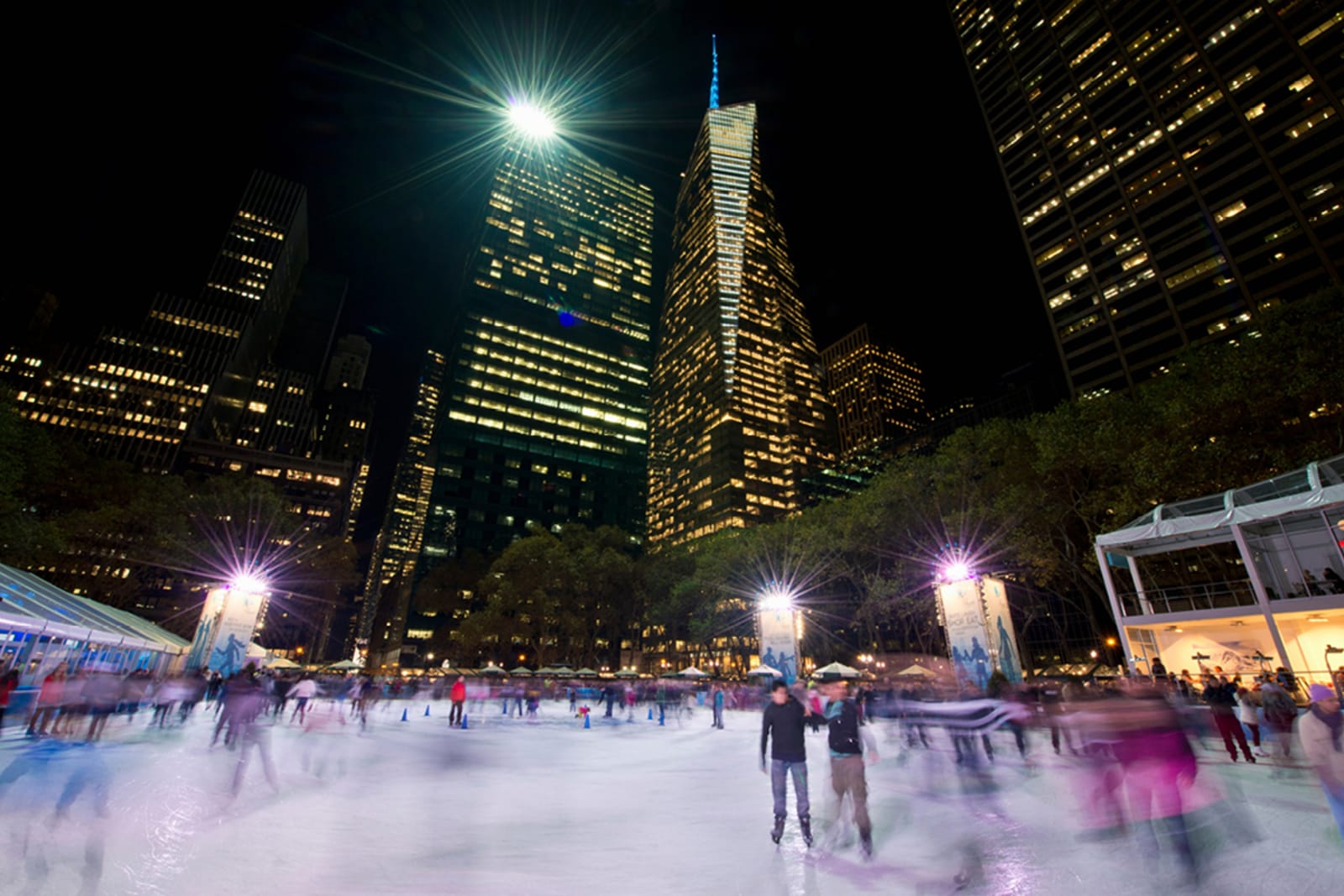 People ice skating at an outdoor rink in New York City