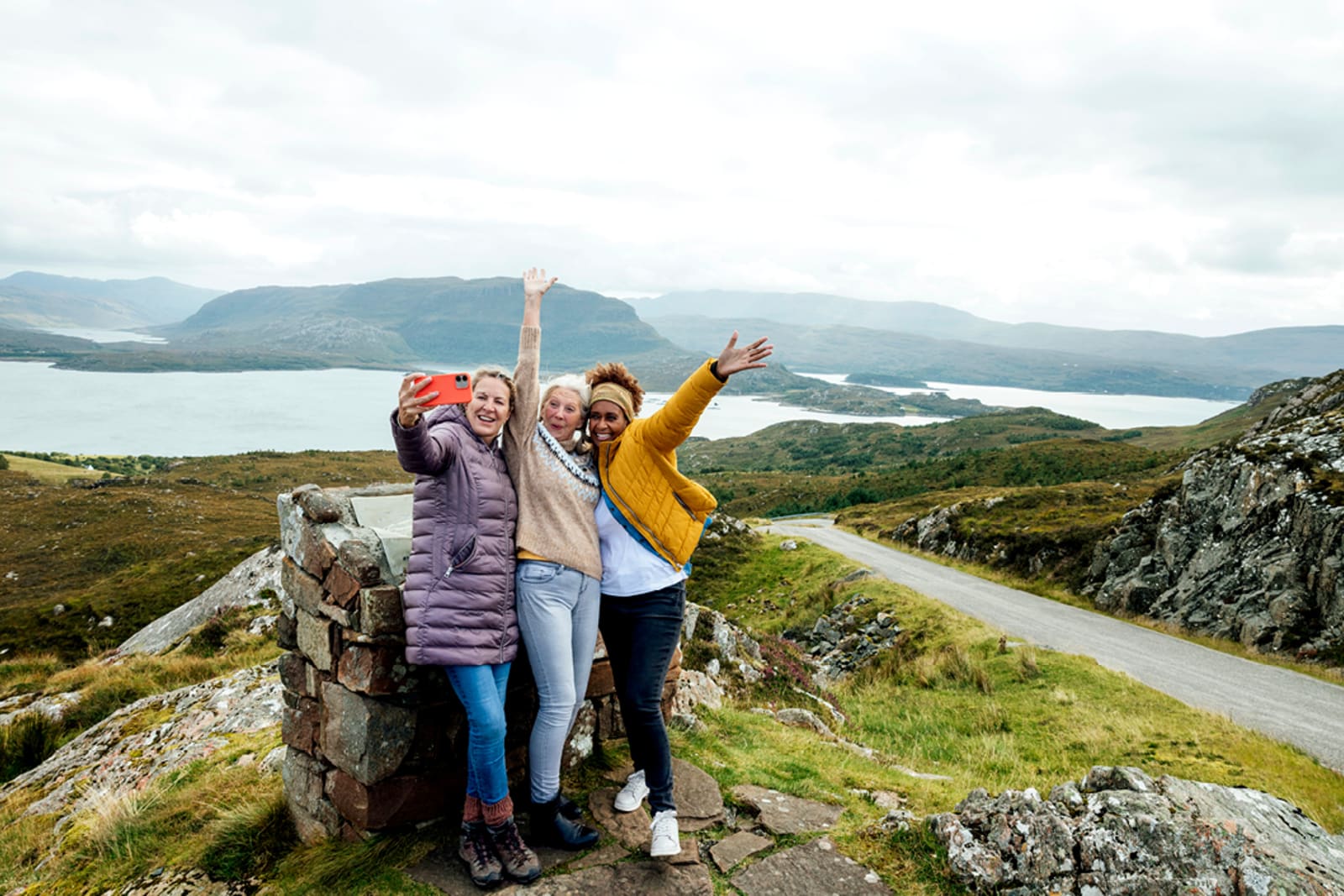 A group of women at the summit of the Applecross Peninsula in Scotland