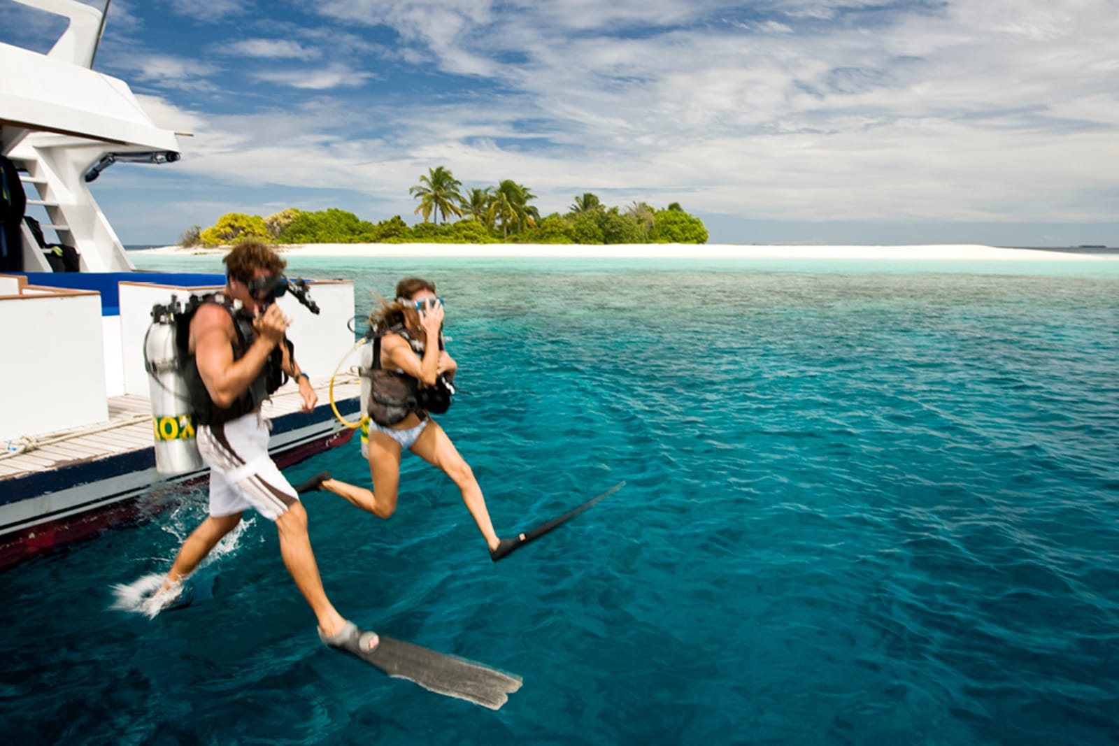 Couple scuba diving in the Maldives