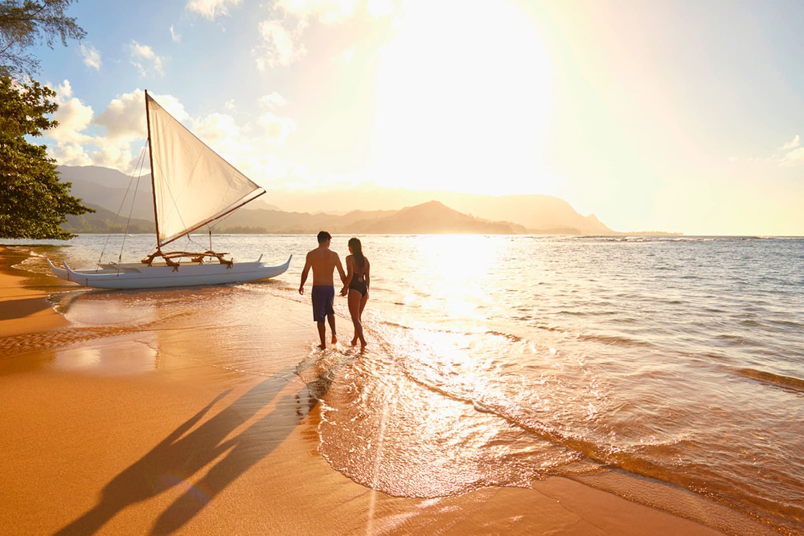 Couple on a beach in Hawai‘i at sunset