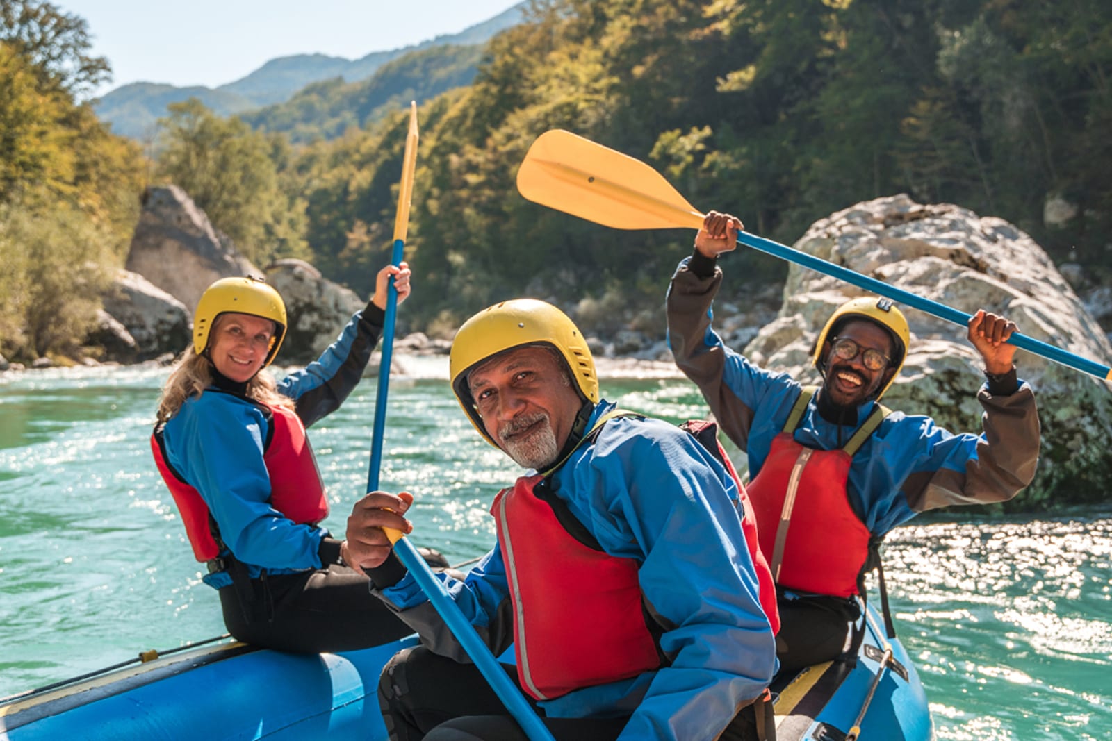 Travellers white water rafting while on an adventure tour