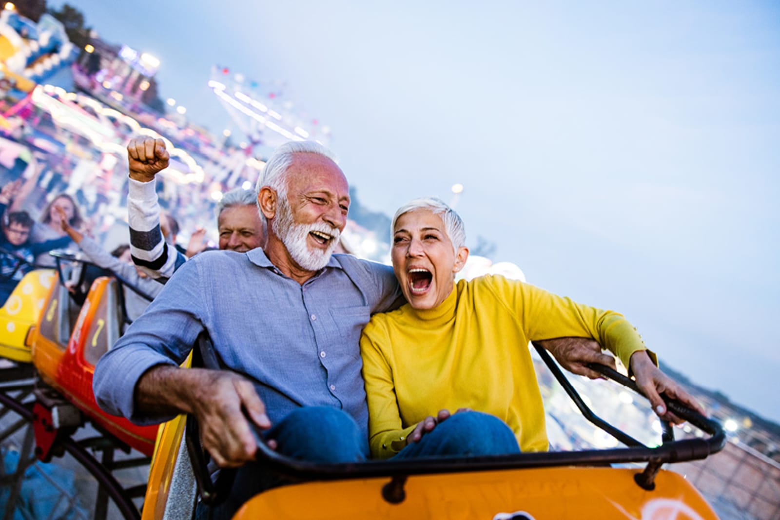 Older couple riding a roller coaster