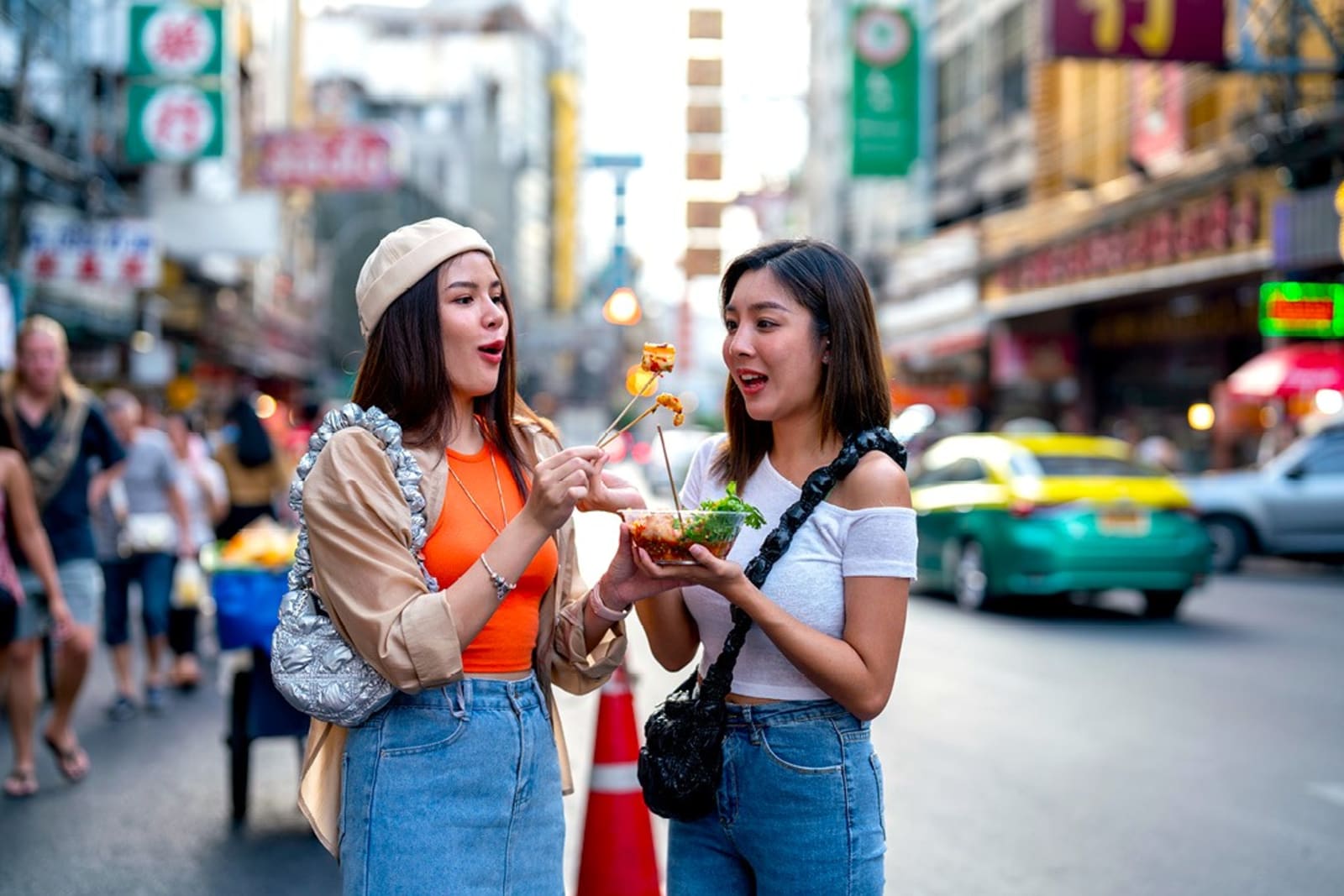 Two women eating street food in Thailand